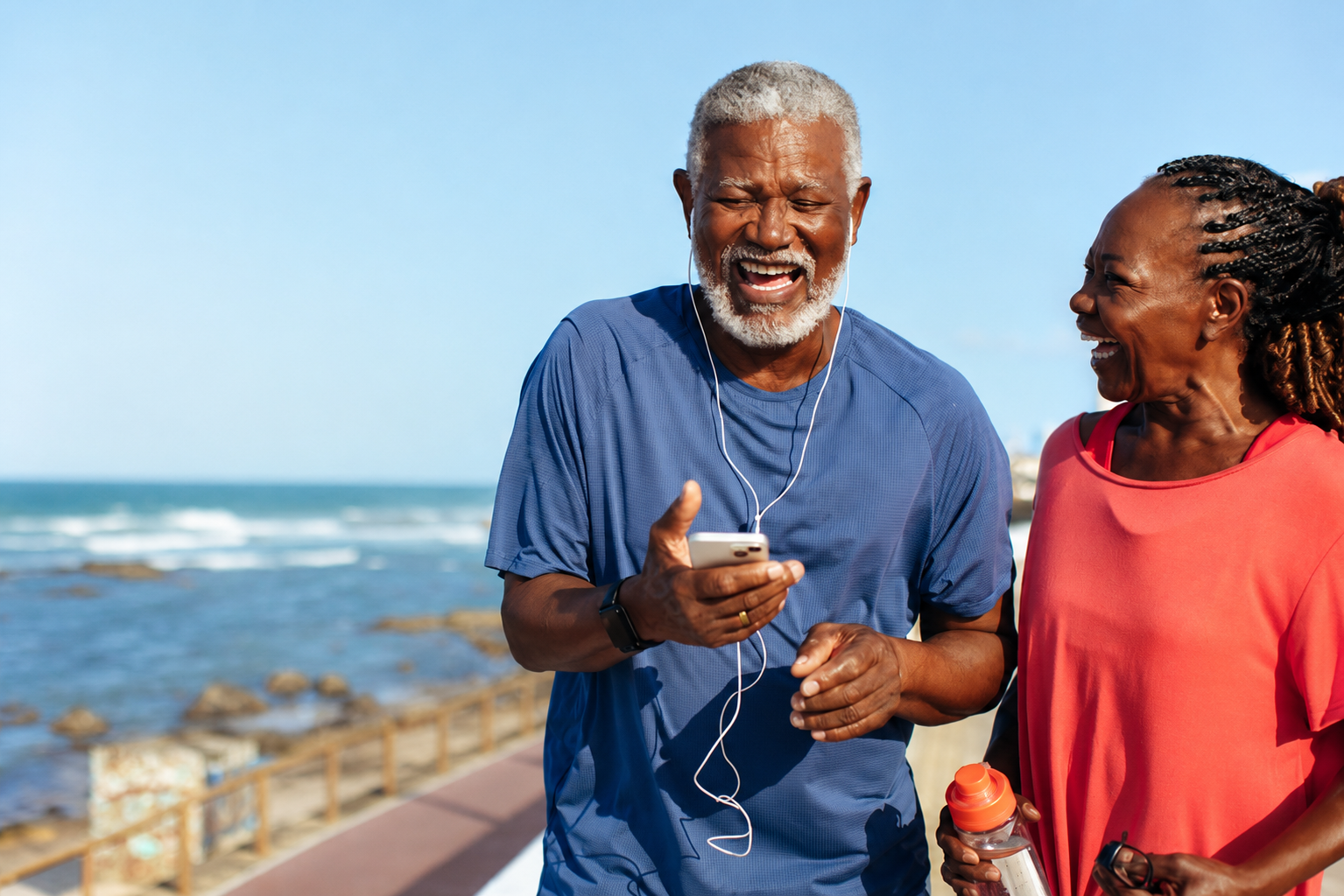 Smiling older couple enjoying time together by the ocean